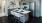kitchen island with sink, breakfast bar, and doorway