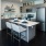kitchen island with sink, breakfast bar, and doorway