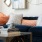 Artistic photo of living couch and coffee table with books and camera