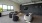 Lounge with couches, chairs, tables, and flat screen TV
